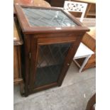 A PINE CABINET WITH A LEADED GLASS DOOR AND TOP