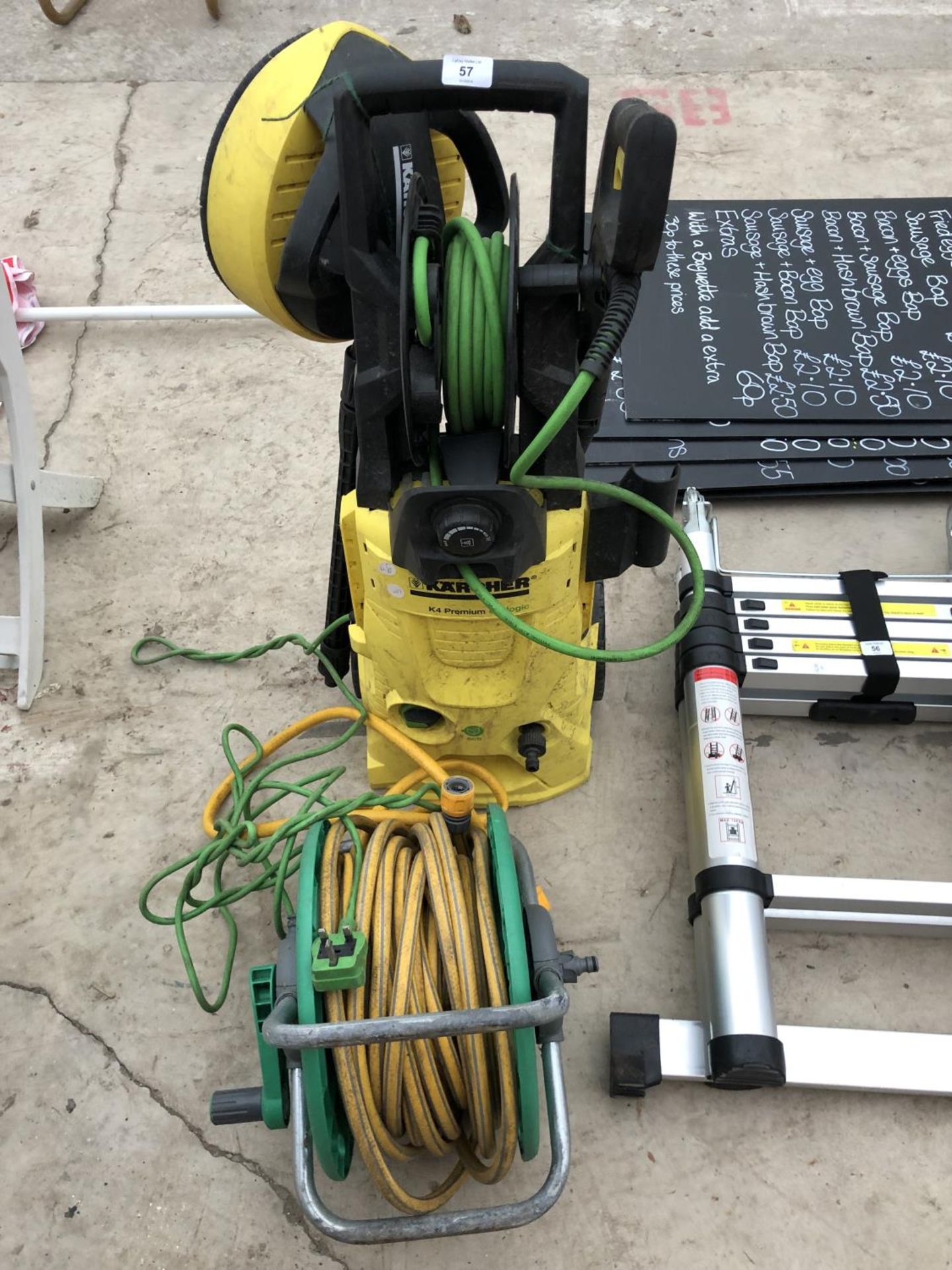 A KARCHER PRESSURE WASHER AND ACCESSORIES, HOSE PIPE AND REEL IN WORKING ORDER