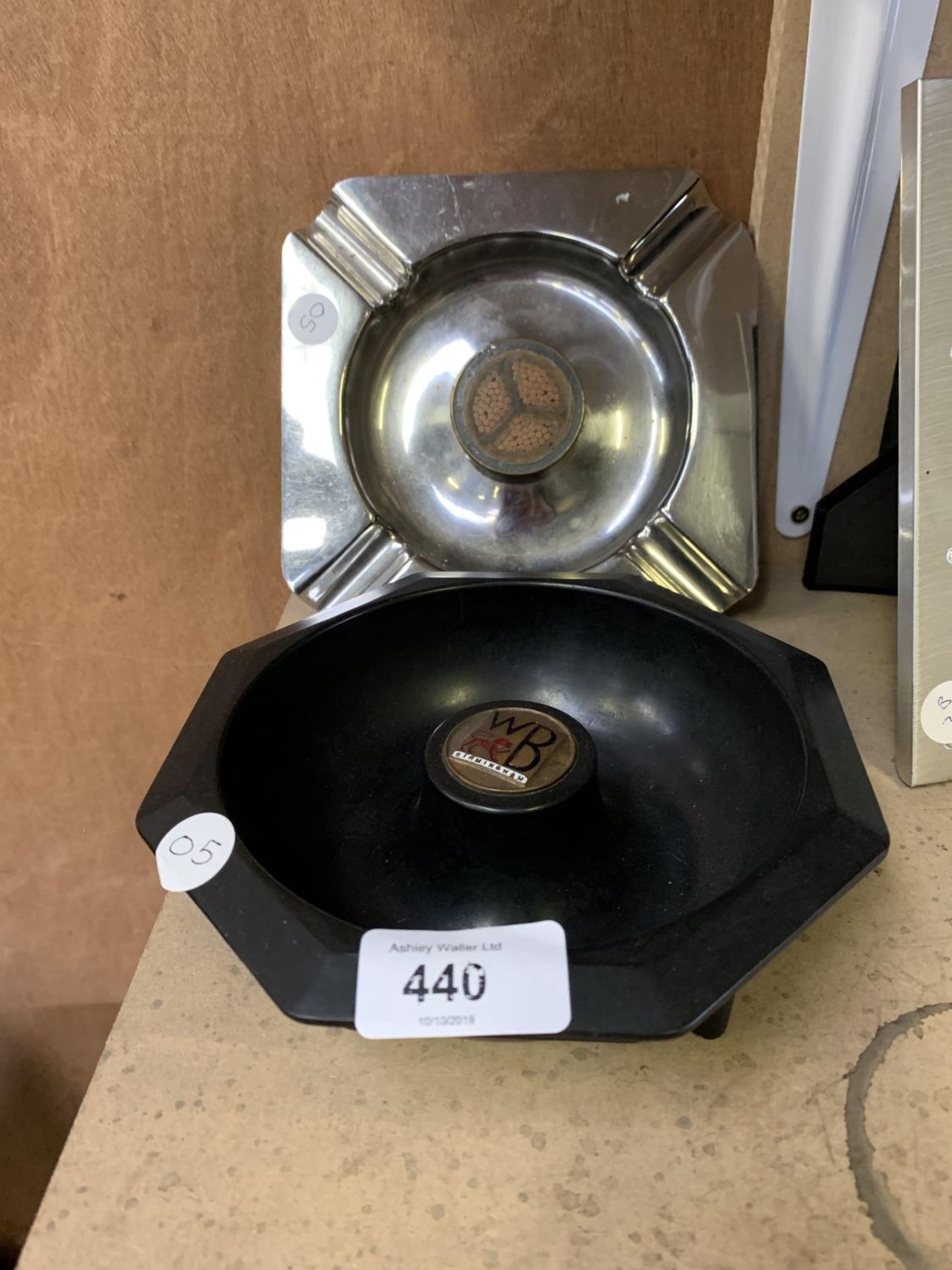 A 1930'S BAKELITE ASHTRAY AND A TRENCH ART MERCEDES ASH TRAY