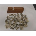 A BONE AND EBONY DOMINOES SET HOUSED IN WOODEN BOX
