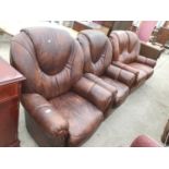 A BROWN LEATHER TWO SEATER SOFA WITH TWO MATCHING ARMCHAIRS AND A BLACK LEATHER FOOTSTOOL