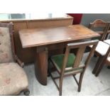 A MAHOGANY DESK ON A CURVED BASE WITH A FURTHER CHAIR