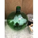 A LARGE GREEN GLASS BOTTLE