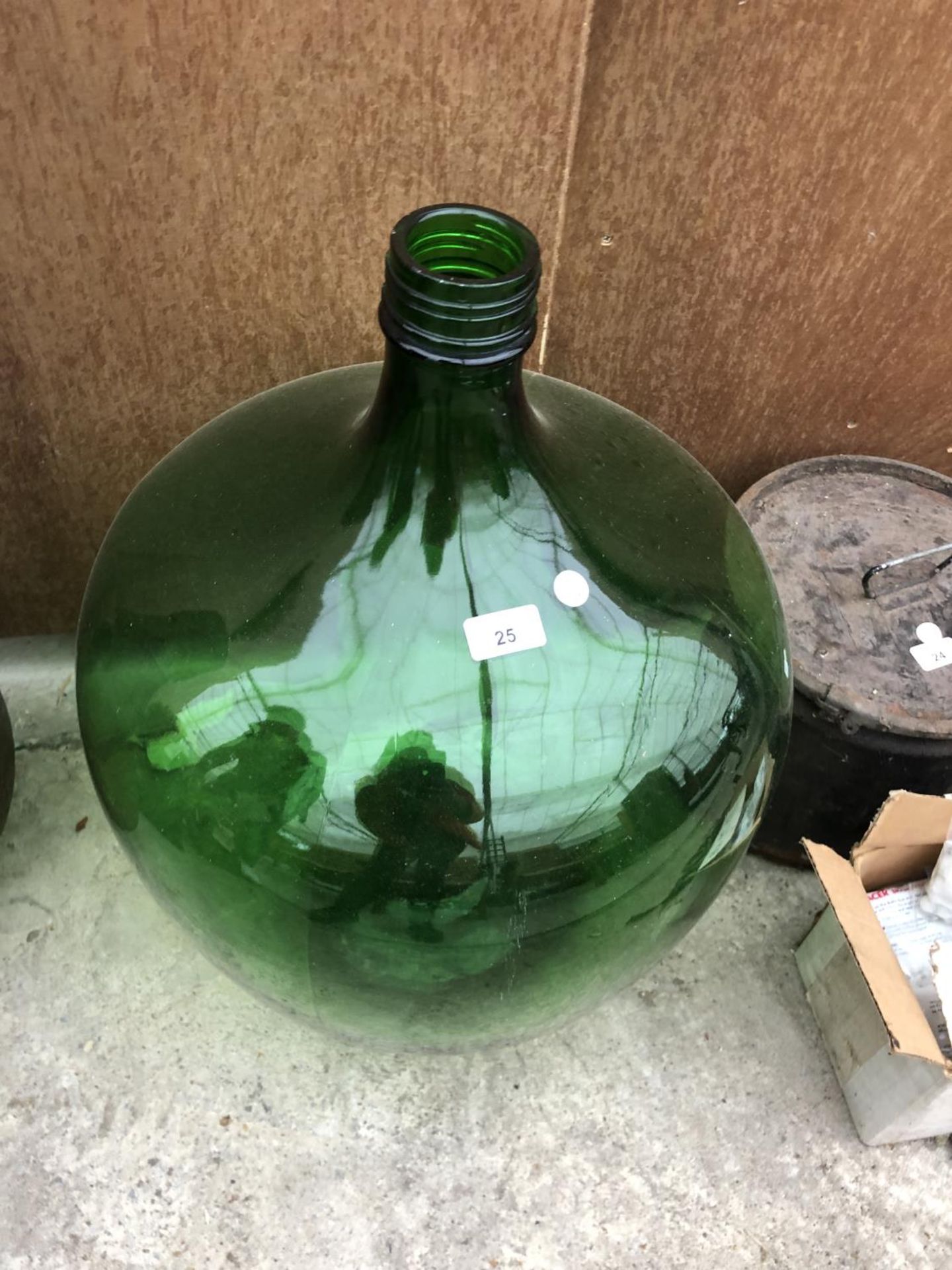 A LARGE GREEN GLASS BOTTLE