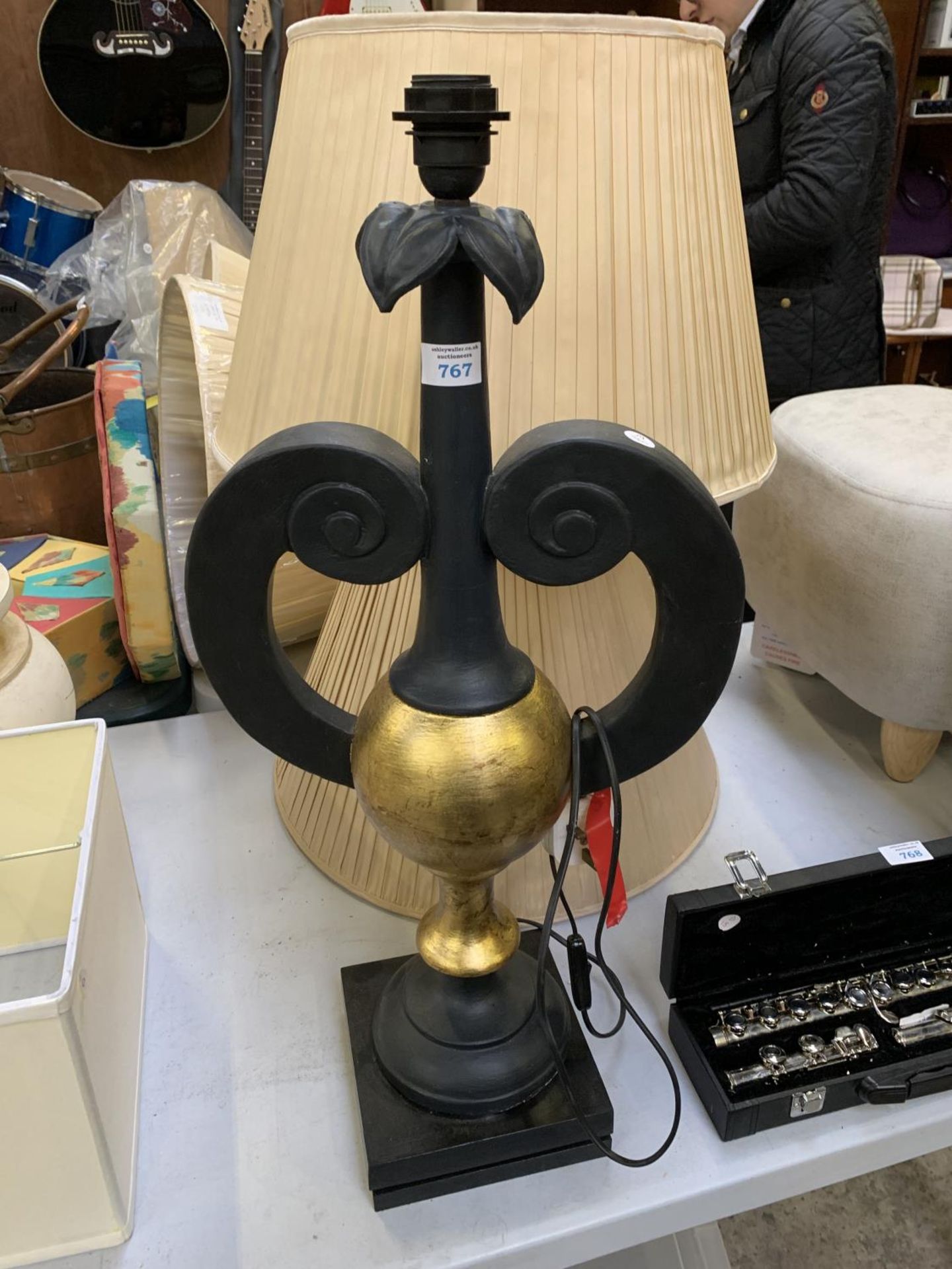 A BLACK AND GOLD LAMP BASE TOGETHER WITH TWO SHADES