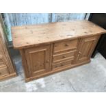 A PINE SIDEBOARD WITH TWO DOORS AND THREE DRAWERS