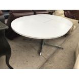 AN EXTENDING WHITE DINING TABLE ON BRUSHED CHROME PEDESTAL SUPPORT