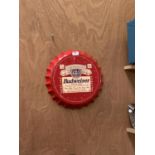 A COLLECTABLE METAL BEER BOTTLE CAP 'BUDWEISER' SIGN