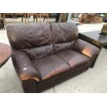 A BROWN LEATHER TWO SEATER SOFA