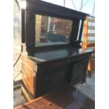 A LARGE MIRROR BACKED OAK SIDEBOARD WITH COPPER ARTS AND CRAFTS STYLE HANDLES