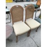 A PAIR OF LIGHT CHERRY RATTAN BACKED DINING CHAIRS WITH UPHOLSTERED SEATS