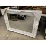A LARGE WHITE ORNATE MIRROR