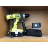 A RYOBI DRILL WITH BATTERY AND CHARGER
