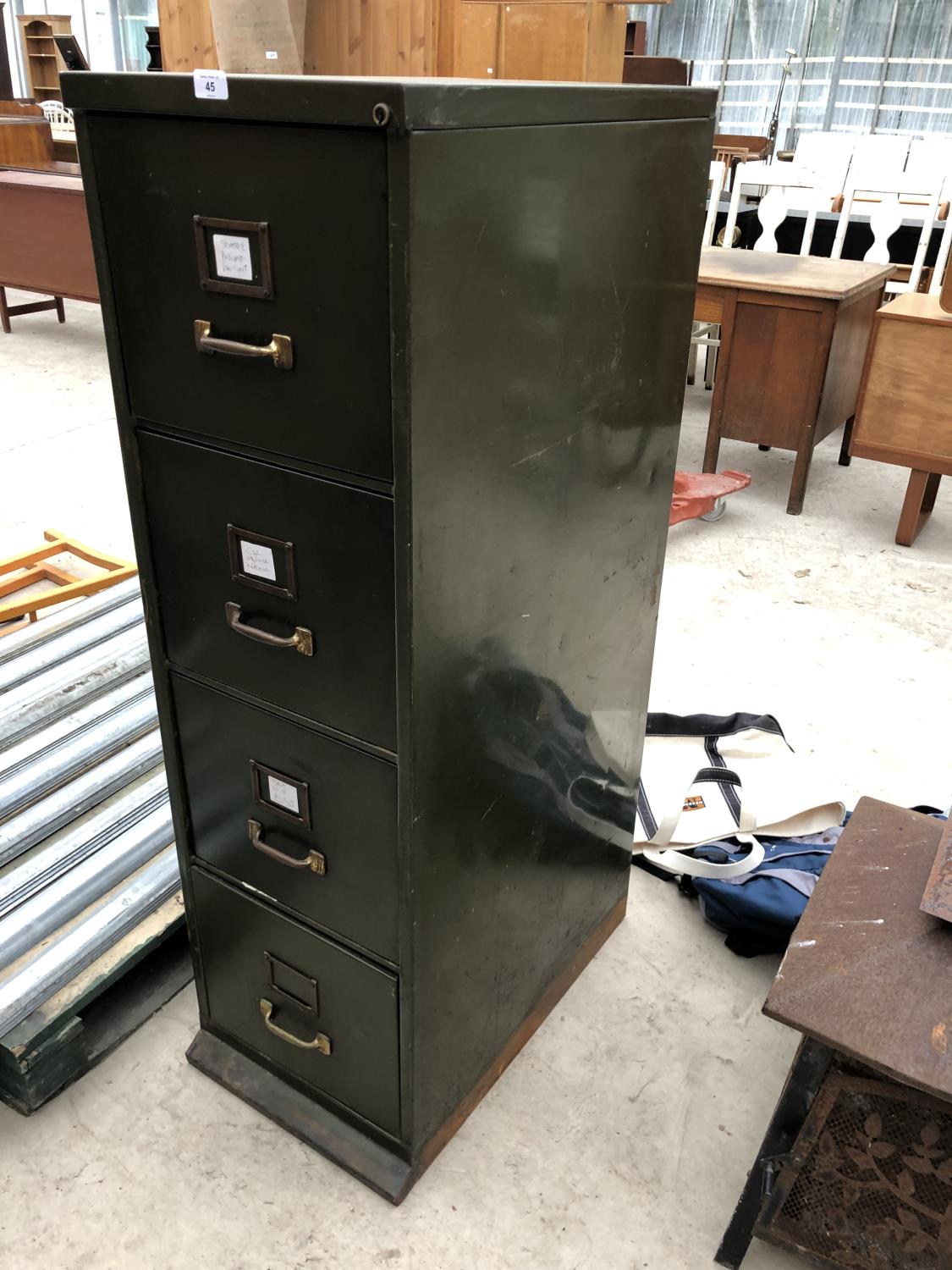 A GREEN METAL VINTAGE FOUR DRAWER FILING CABINET