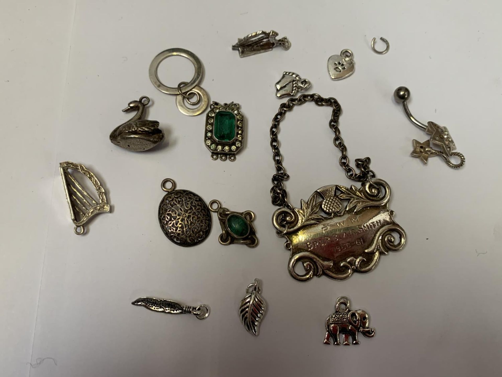 A COLLECTION OF SILVER ITEMS TO INCLUDE CHARMS ETC