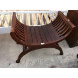 A MAHOGANY CURVED SEAT STOOL