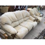 A MAHOGANY CREAM UPHOLSTERED THREE SEATER SOFA AND TWO ARMCHAIRS