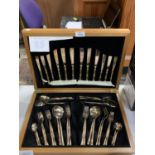 A WOODEN CASED CANTEEN OF CUTLERY WITH BAMBOO HANDLES