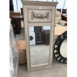 A TALL GREY MIRROR WITH ORNATE PANEL