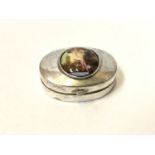 A MINIATURE SILVER PILL BOX WITH NUDE CARTOUCHE TOP