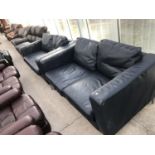 A BLACK LEATHER TWO SEATER SOFA AND ARMCHAIR