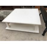 A MODERN WHITE SQUARE COFFEE TABLE WITH LOWER SHELF