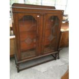 AN OAK GLASS FRONTED DISPLAY CABINET