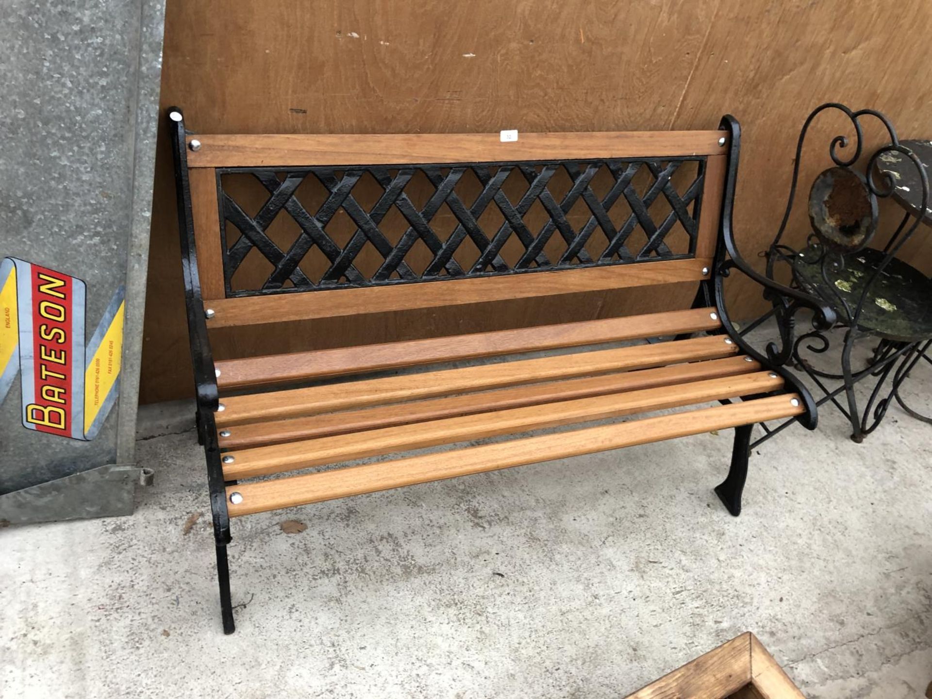 A WOODEN GARDEN BENCH WITH CAST SLATTED BACK AND ENDS - Image 2 of 2