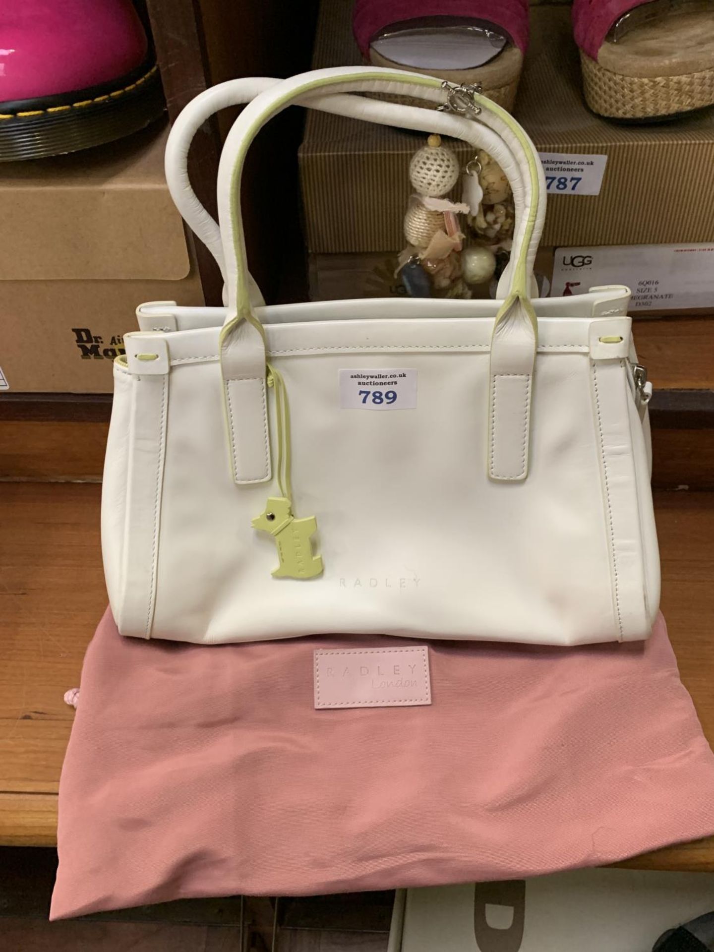 A WHITE RADLEY BAG TOGETHER WITH STORAGE BAG