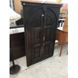 AN OAK ARCHED DOUBLE DOOR IN A FRAME