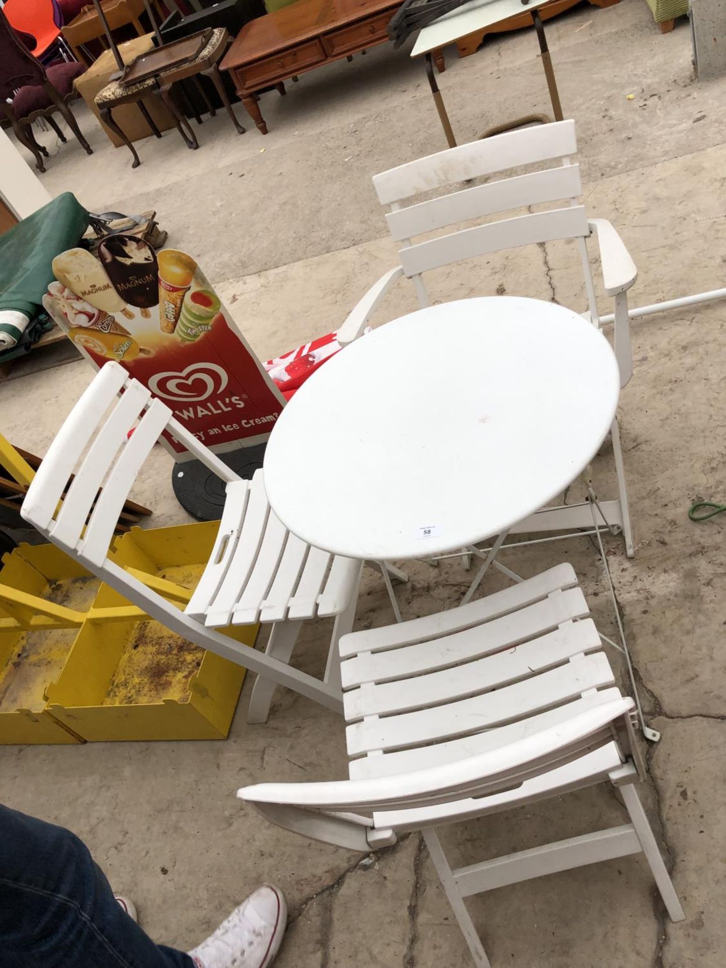 A WHITE GARDEN TABLE AND THREE CHAIRS