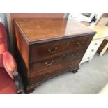 A MAHOGANY DESK WITH PULL OUT WRITING TOP AND THREE LONG DRAWERS