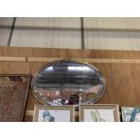 AN OVAL DECORATIVE FRAMED BEVEL EDGED MIRROR