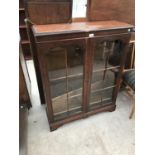 A MAHOGANY CABINET WITH TWO GLAZED PANEL DOORS