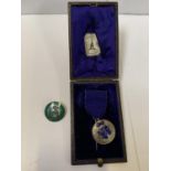 A CASED NATIONAL TRAINING SCHOOL OF COOKERY SILVER MEDAL AND FURTHER SILVER AND ENAMEL BADGE