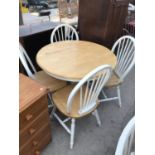 A BEECH AND WHITE PAINTED CIRCULAR DINING TABLE WITH FOUR MATCHING SPINDLE BACK CHAIRS