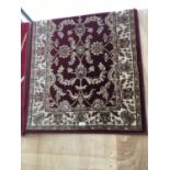 A BROWN AND CREAM PATTERED RUG