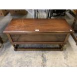 A MAHOGANY LIDDED UNIT WITH CARVED FLORAL DESIGN