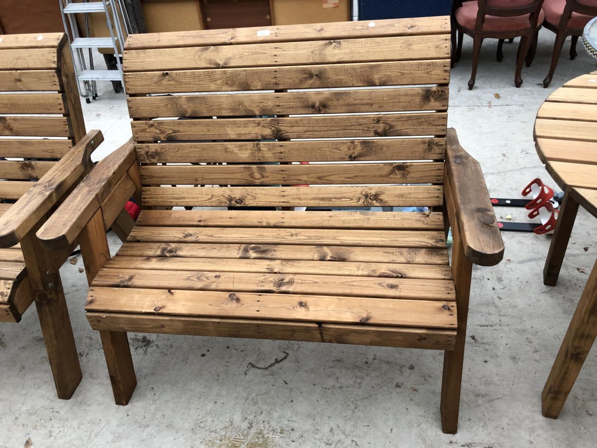 A TWO SEATER WOODEN GARDEN BENCH