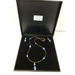 A BOXED SILVER NECKLACE AND EARRINGS SET WITH BLUE STONES