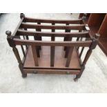 A CANTERBURY STYLE MAHOGANY MAGAZINE RACK ON CASTERS