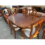 A CHERRY EXTENDING DINING TABLE WITH FOUR MATCHING DINING CHAIRS AND TWO CARVERS WITH CREAM