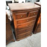 A CHERRY WOOD BOW FRONT CHEST OF TWO SHORT AND FOUR LONG DRAWERS