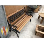 A WOODEN GARDEN BENCH WITH CAST SLATTED BACK AND ENDS