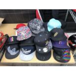 A LARGE COLLECTION OF FLAT BACK CAPS ETC