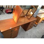 A STAG TEAK DRESSING TABLE WITH SIX DRAWERS AND A TRIPLE MIRROR