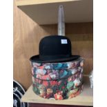 A BLACK BOWLER HAT TOGETHER WITH STORAGE BOX