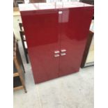 A MODERN HABITAT RED METAL CABINET WITH FOUR DOORS