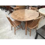 AN ERCOL STYLE ELM DINING TABLE AND FOUR DINING CHAIRS