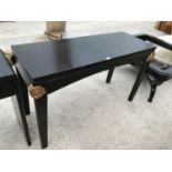 A MODERN BLACK HALL TABLE WITH GILDED SCROLL DETAIL TO TOP OF LEGS